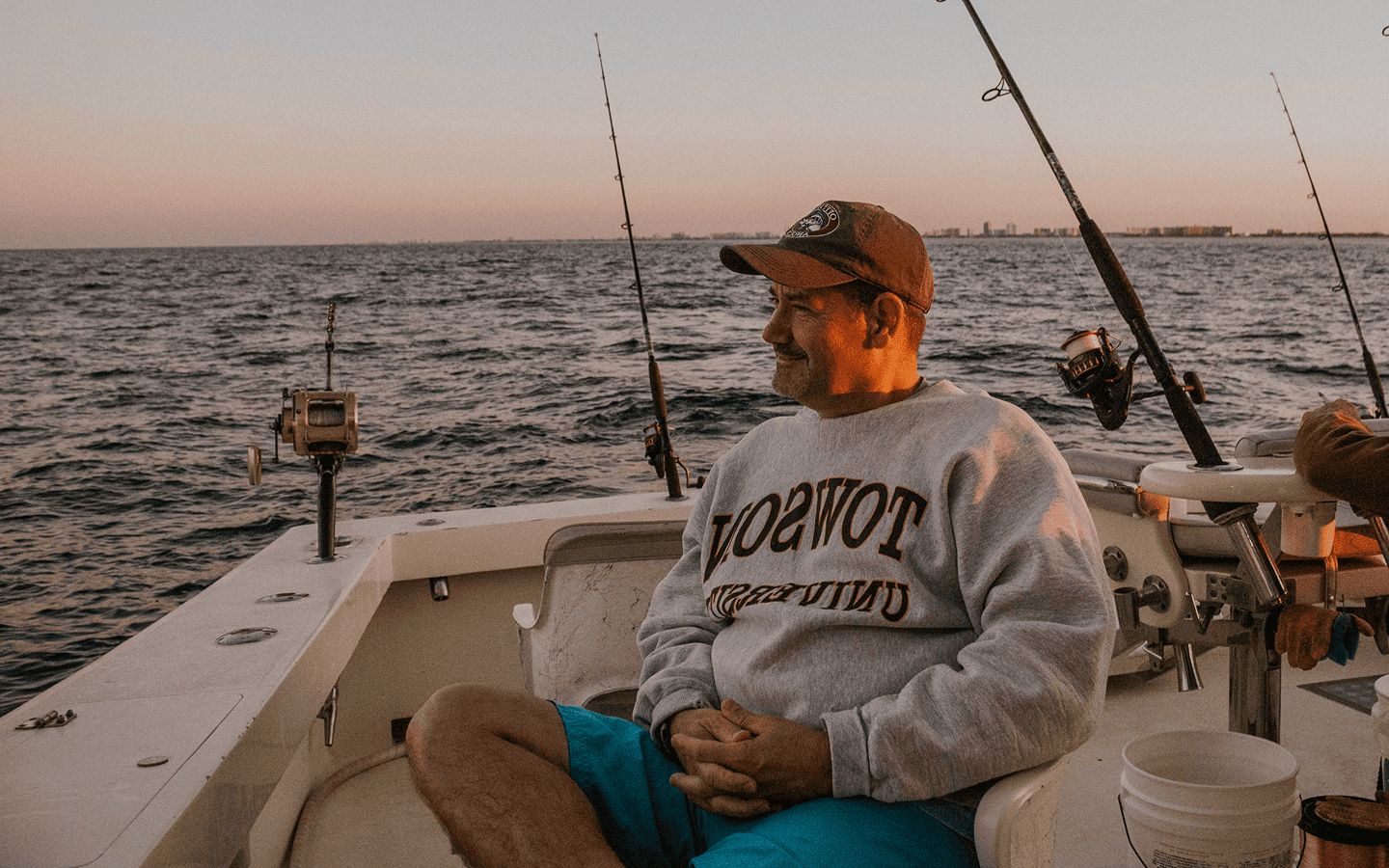 Man looking away from a boat during a fishing charter trip in Lombok