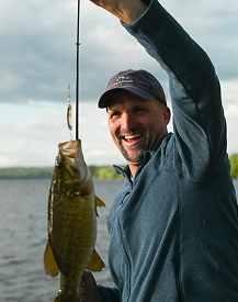 Photo of someone looking at a fish they just fished in lombok with magic fishing