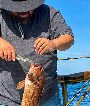 Photo of someone holding a fish during a Magic hand fishing charter trip in Lombok