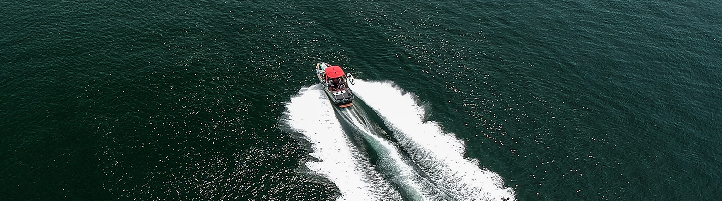 Photo of a boat from the sky, moving in the sea of Lombok